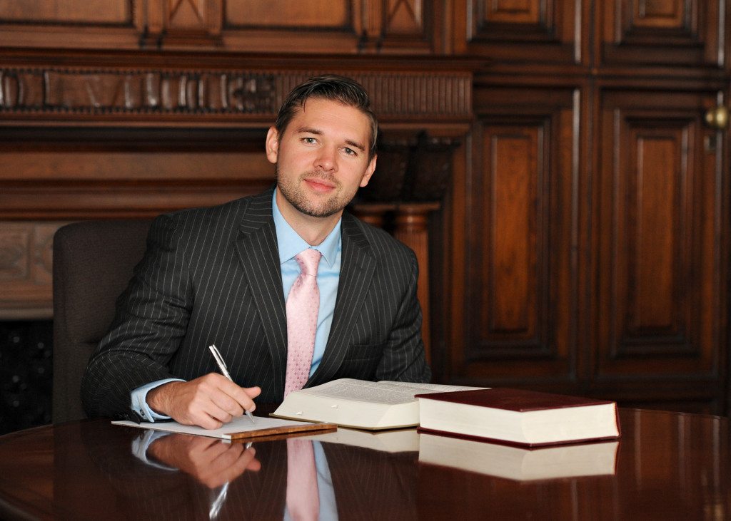 attorney sitting at table with legal documents