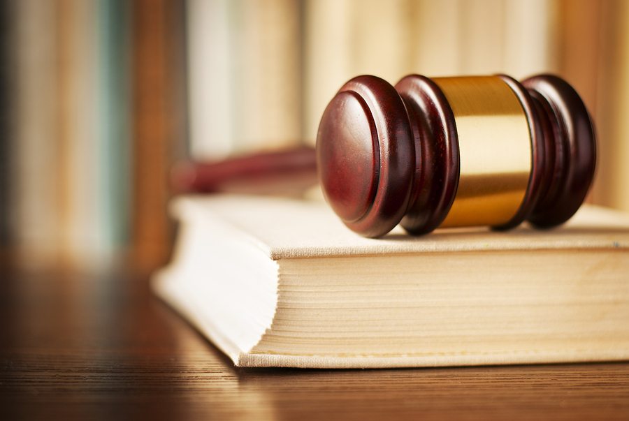 brown and gold gavel with book