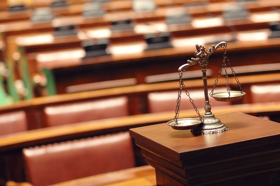 empty courtroom with scales of justice