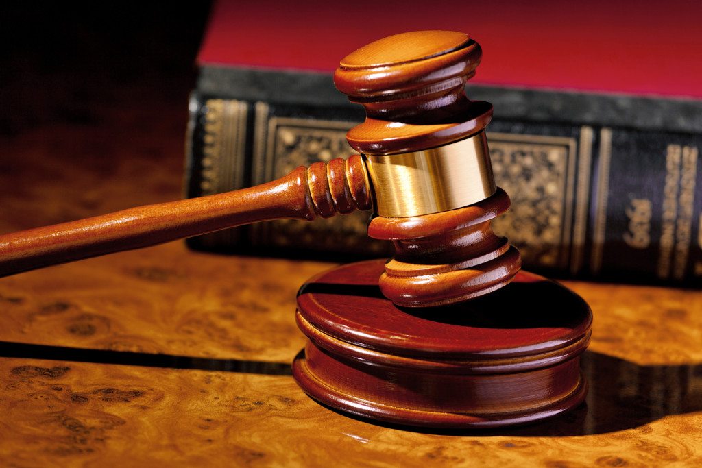 brown gavel with law books in background