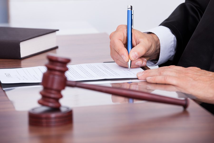 judge with gavel signing legal document nursing home abuse lawsuit
