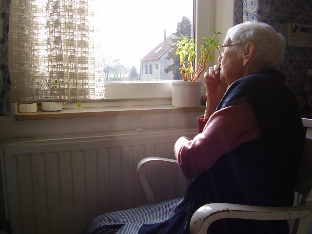 elderly woman at nursing home window