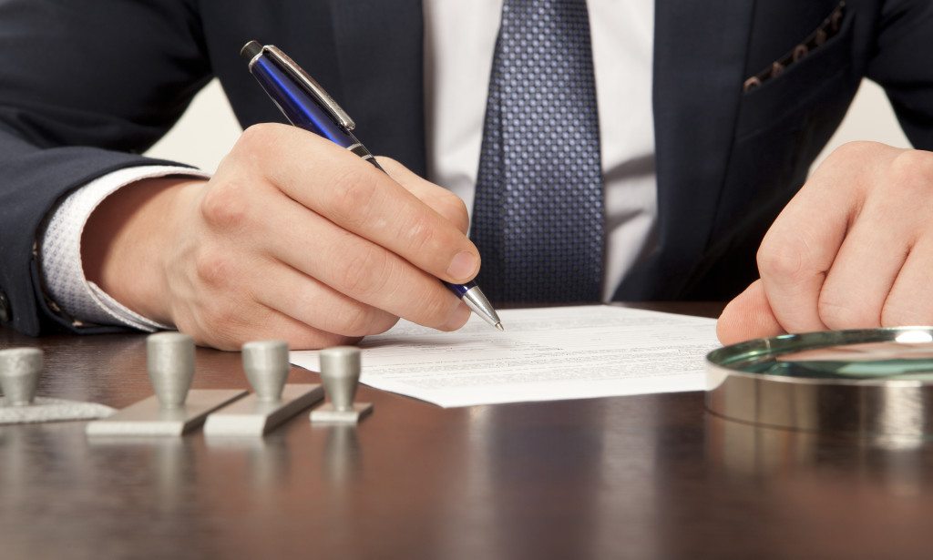 Lawyer, notary signs the documents from our office