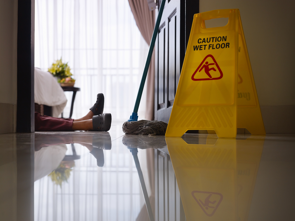Philadelphia Slip and Fall Lawyer- person fallen with caution wet floor sign